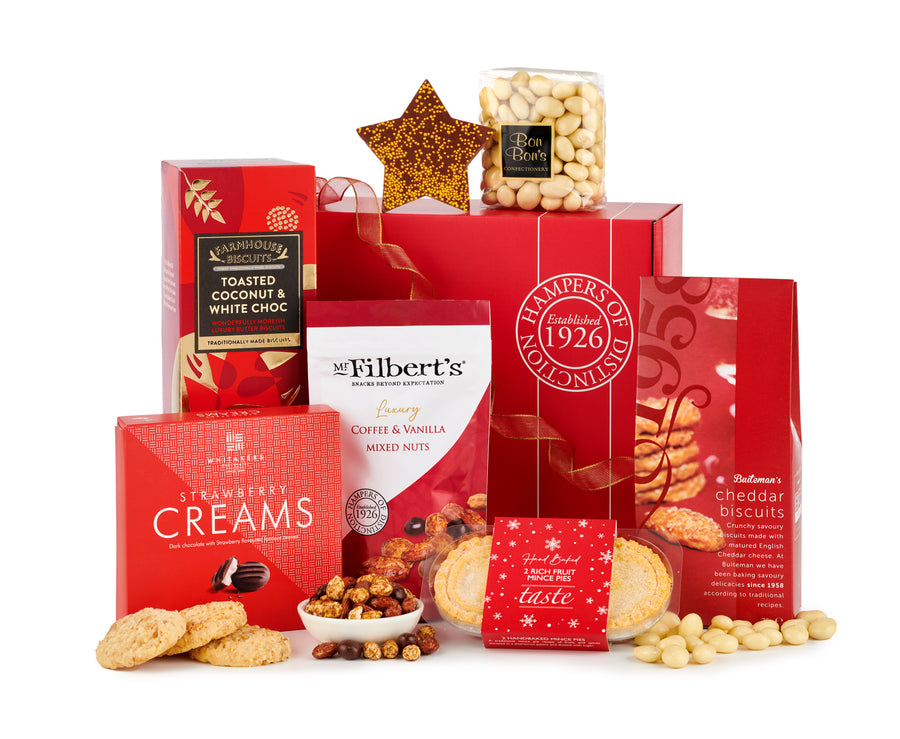 The Snow Drop christmas hamper by spicers of hythe. Containing Mr Filbert's coffee & vanilla mixed nuts, strawberry creams and a range of red packaged goods.